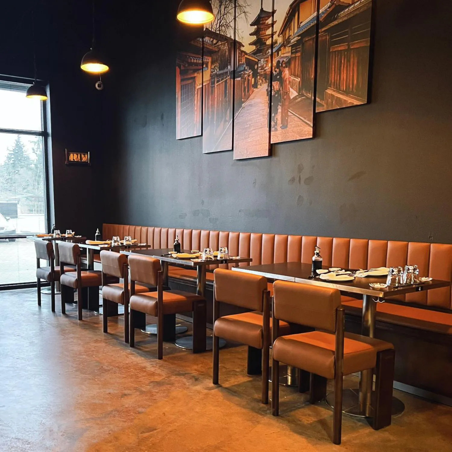 Spacious dining room with booths, chairs and Japanese-themed art at Ginza Sushi and Ramen, a Japanese Restaurant in Salem
