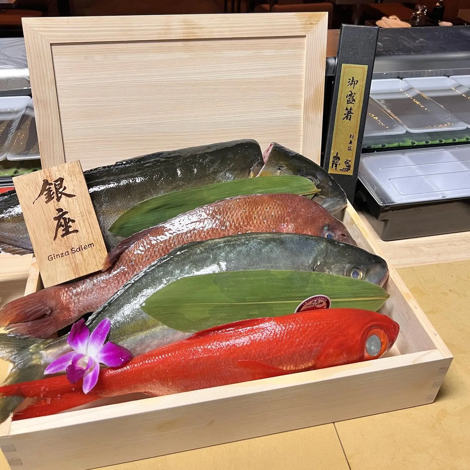 Assorted fresh fish presented in a wooden box at Ginza Sushi and Ramen, a Japanese Restaurant in Salem
