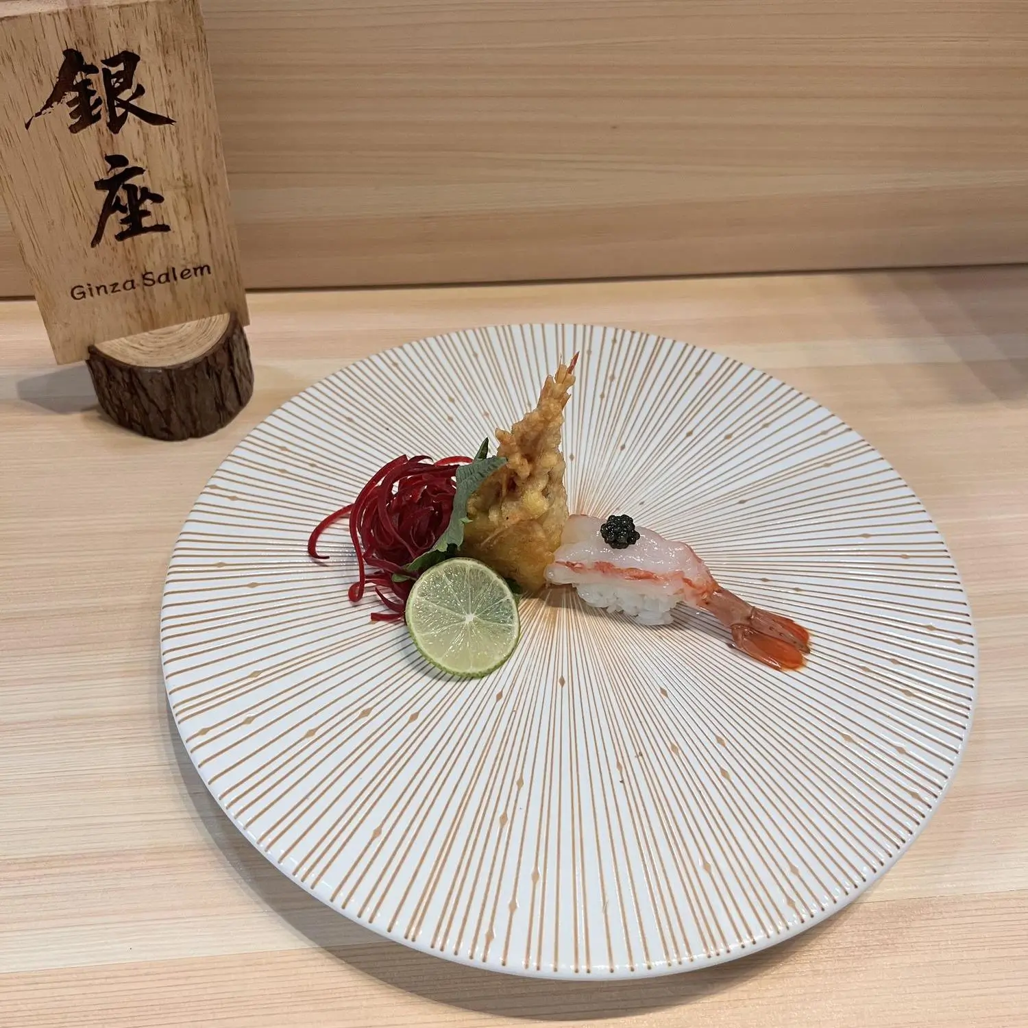 Shrimp nigiri served with tempura and lime at Ginza Sushi and Ramen, a Japanese Restaurant in Salem